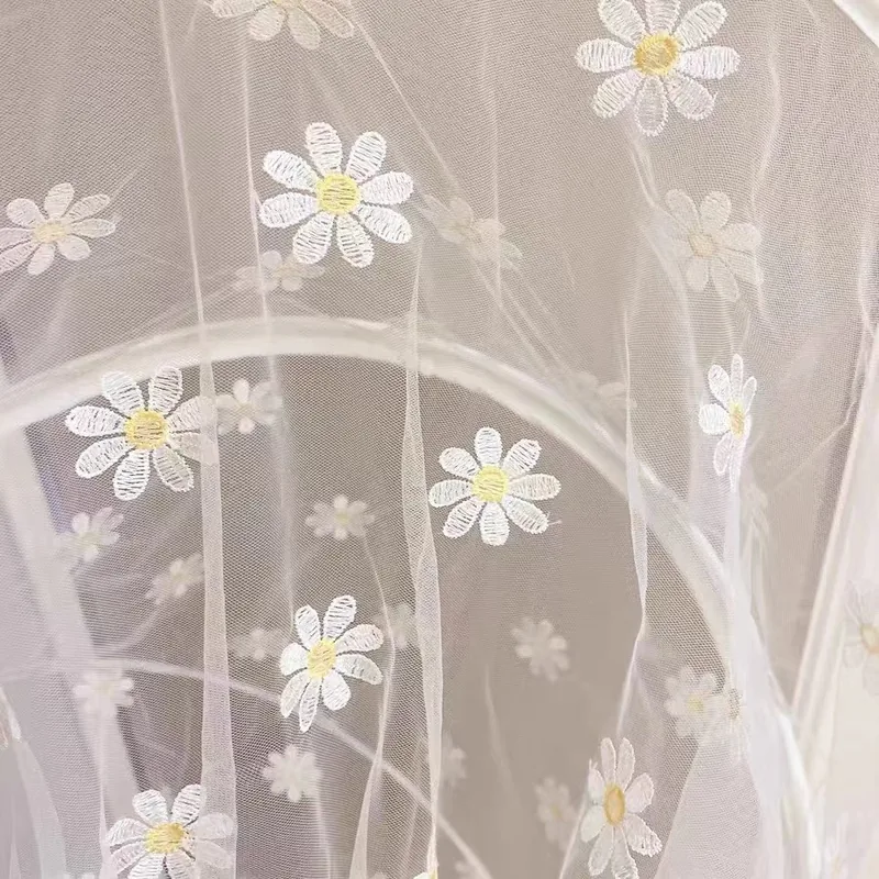 Embroidered daisies on fine mesh