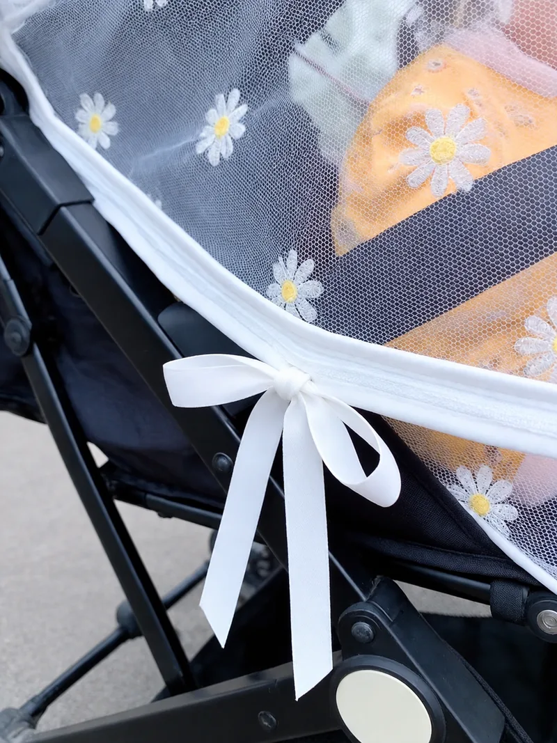 Ribbon ties to the stroller frame